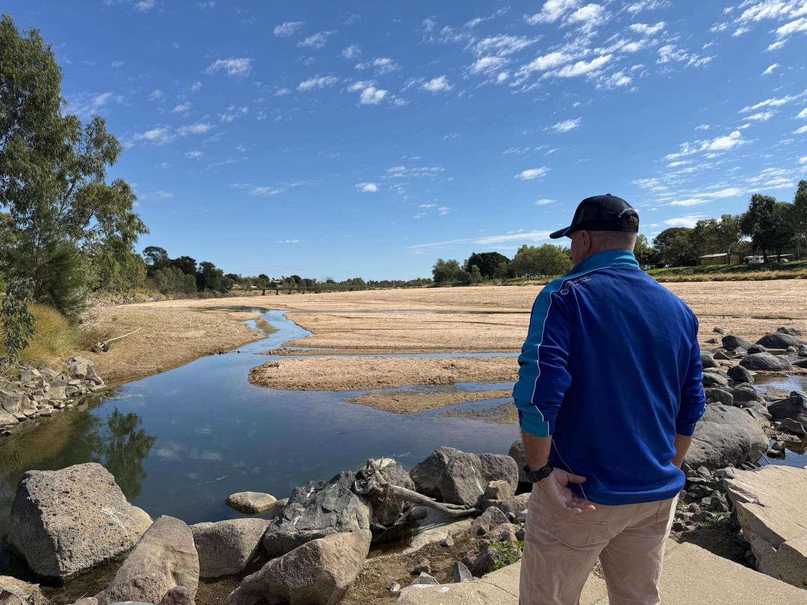 Councillor Shane McCarthy surveys the Flinders River, where the spread of parthenium weed is of serious concern.jpg